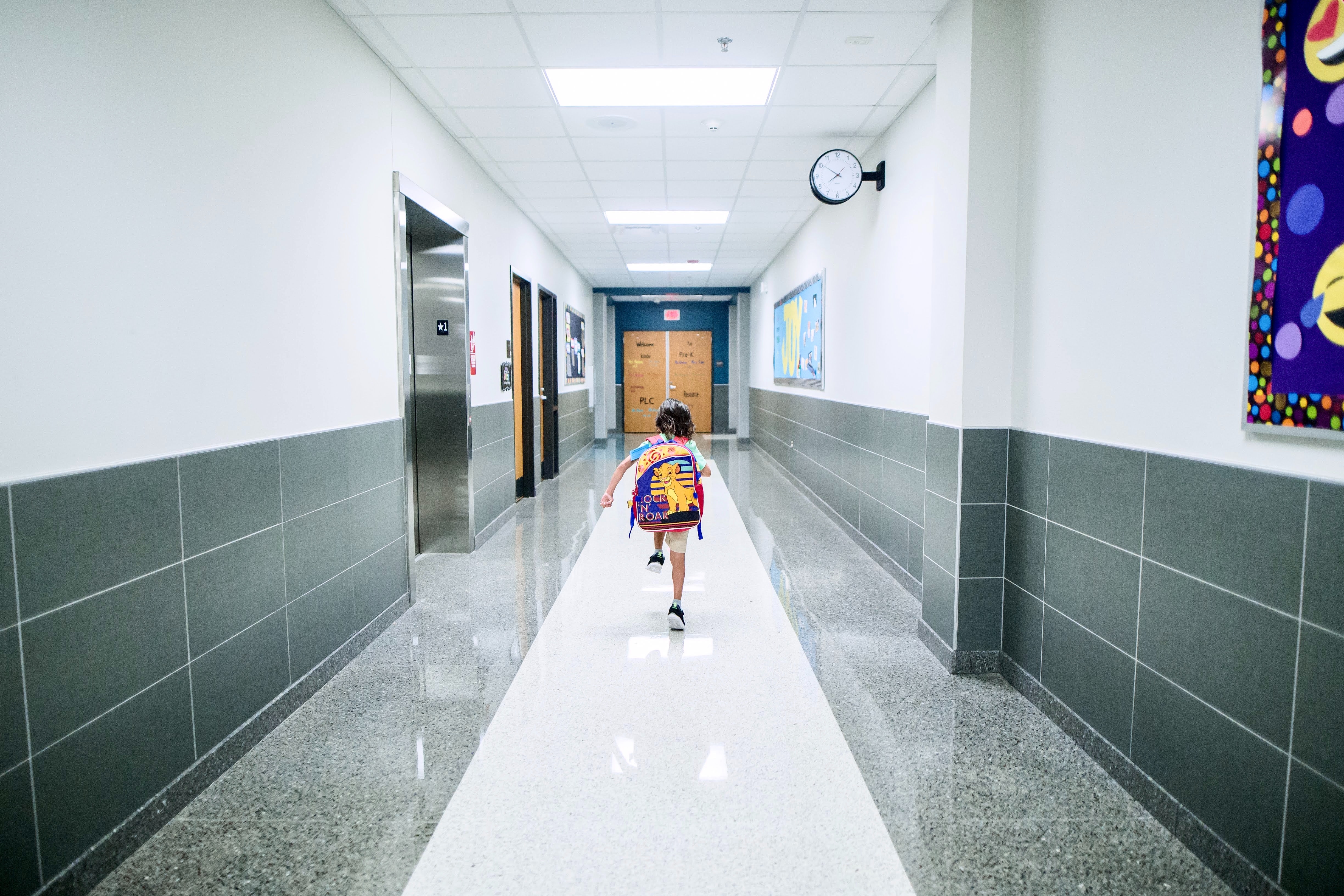 child walking down a hall at school